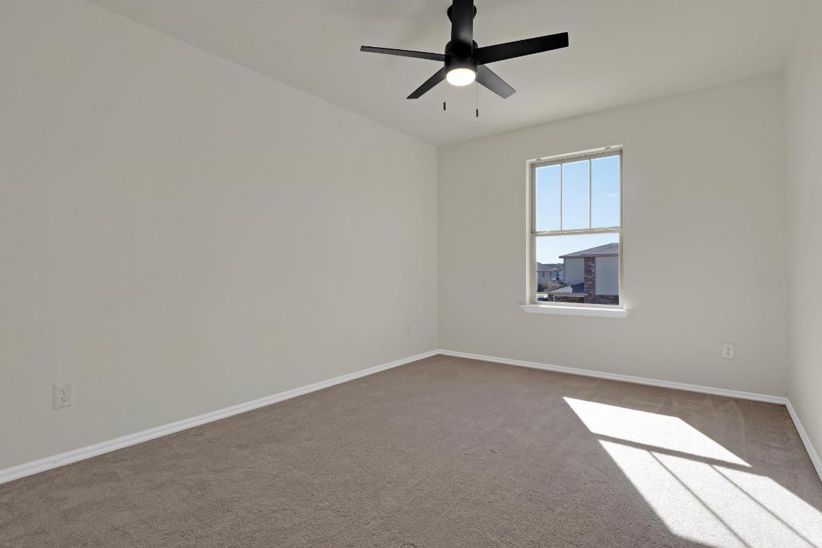 449 Stone Water Lane Jarrell, TX 76537 - Photo 13 of 21 an empty room with a window and a fan