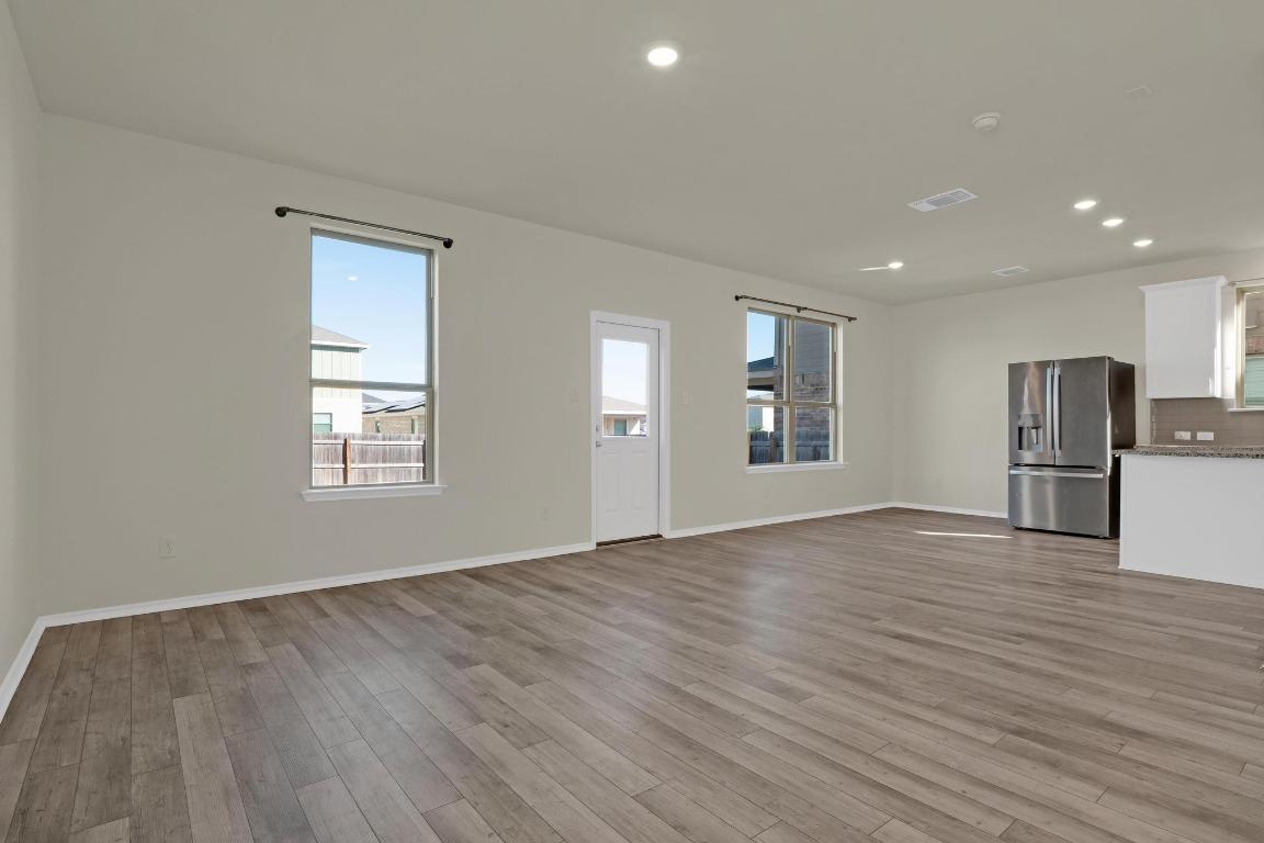 449 Stone Water Lane Jarrell, TX 76537 - Photo 4 of 21 a view of empty room with wooden floor
