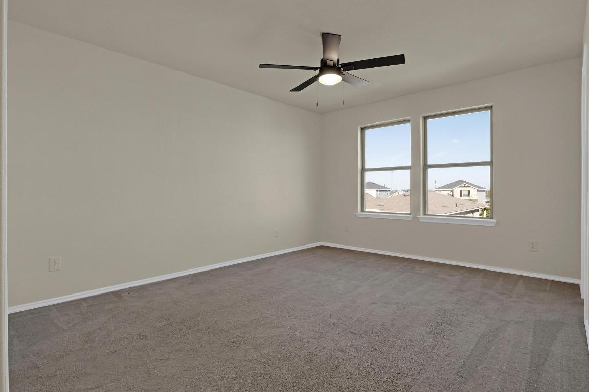 449 Stone Water Lane Jarrell, TX 76537 - Photo 8 of 21 an empty room with a window and a fan