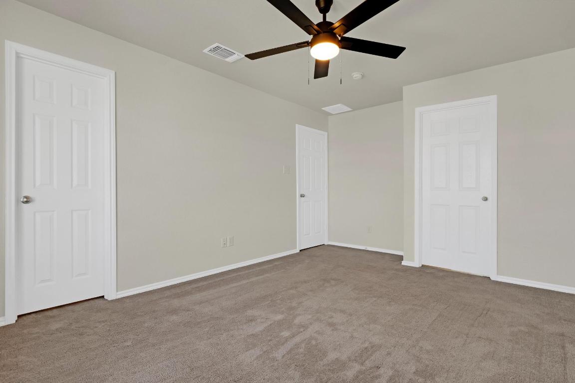 449 Stone Water Lane Jarrell, TX 76537 - Photo 9 of 21 an empty room with a fan & a ceiling fan