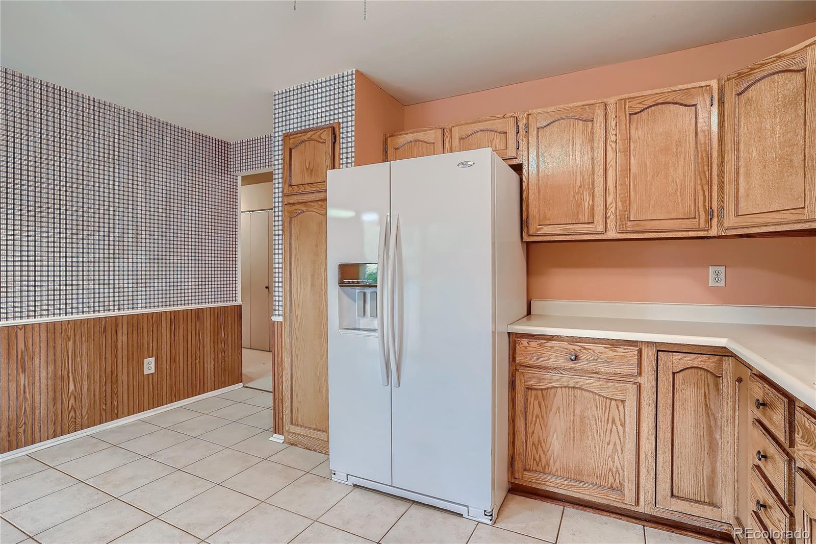 6 Shetland Court Highlands Ranch, CO 80130 - Photo 15 of 33 a kitchen with stainless steel appliances a refrigerator and cabinets