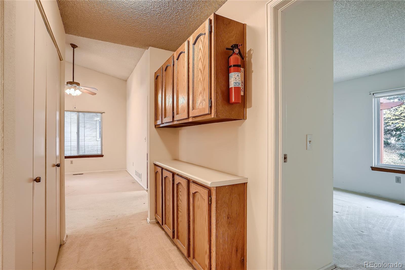 6 Shetland Court Highlands Ranch, CO 80130 - Photo 16 of 33 a view of a hallway with wooden floor and staircase