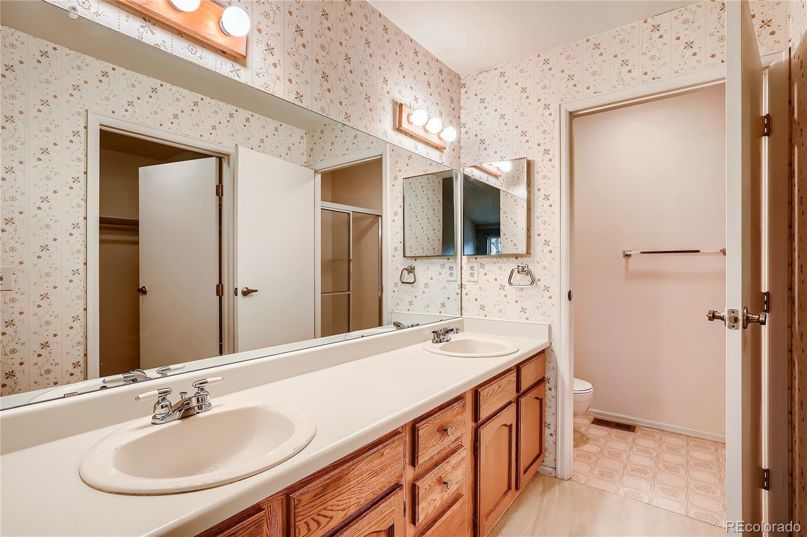 6 Shetland Court Highlands Ranch, CO 80130 - Photo 21 of 33 a bathroom with a double vanity sink and mirror