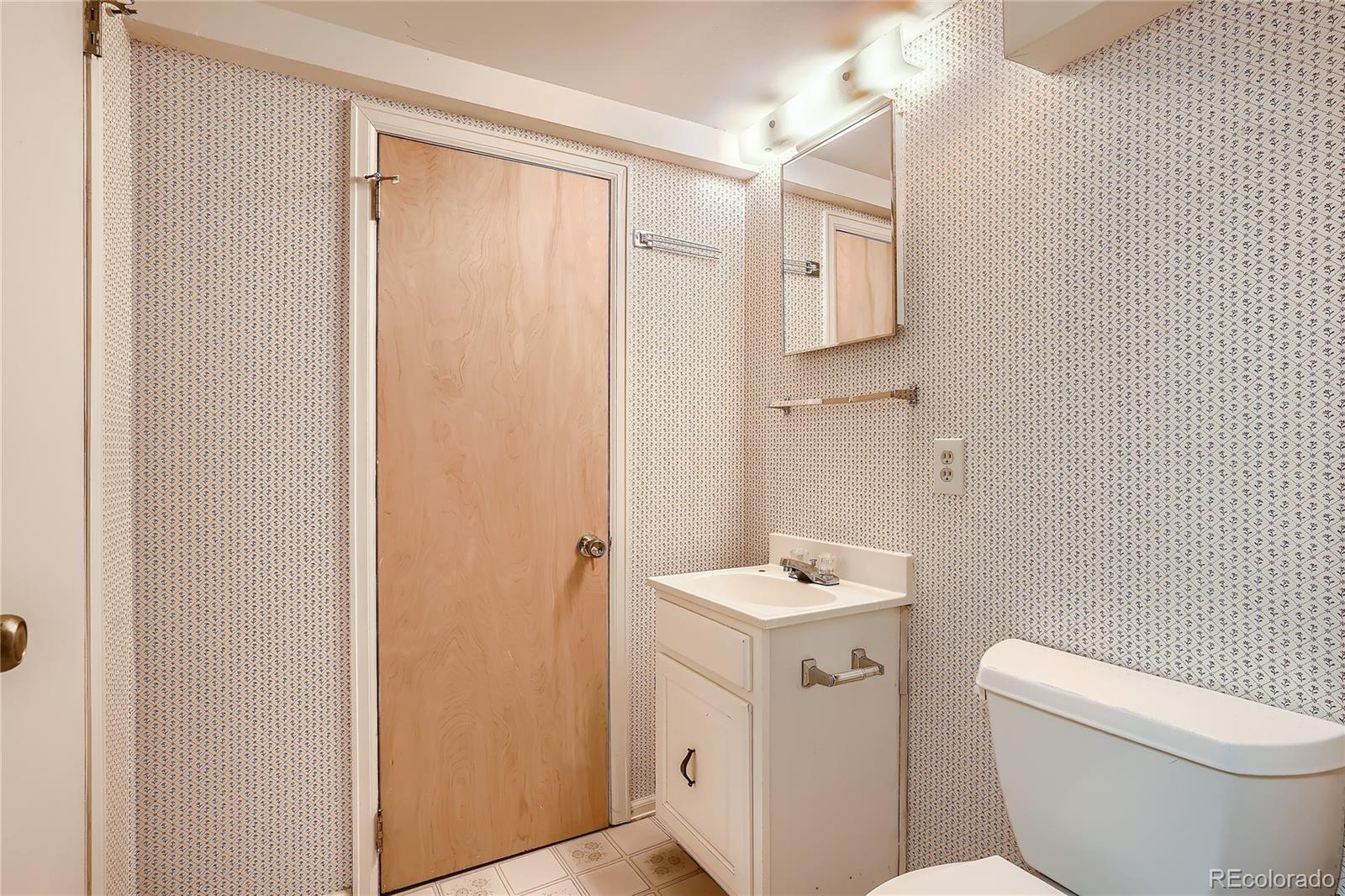 6 Shetland Court Highlands Ranch, CO 80130 - Photo 30 of 33 a bathroom with a sink a toilet and shower