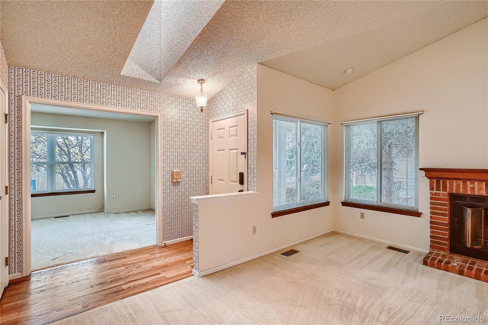 6 Shetland Court Highlands Ranch, CO 80130 - Photo 4 of 33 an empty room with windows and entrance