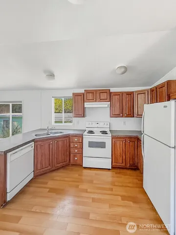 a kitchen with a refrigerator and a stove top oven