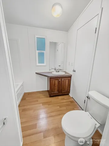 a bathroom with a tub toilet and sink