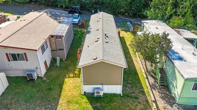 an aerial view of a house with a yard