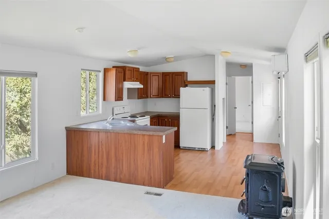 an empty room with wooden floor and a window