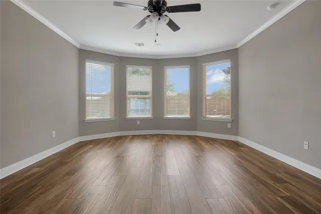 wooden floor in an empty room with a window