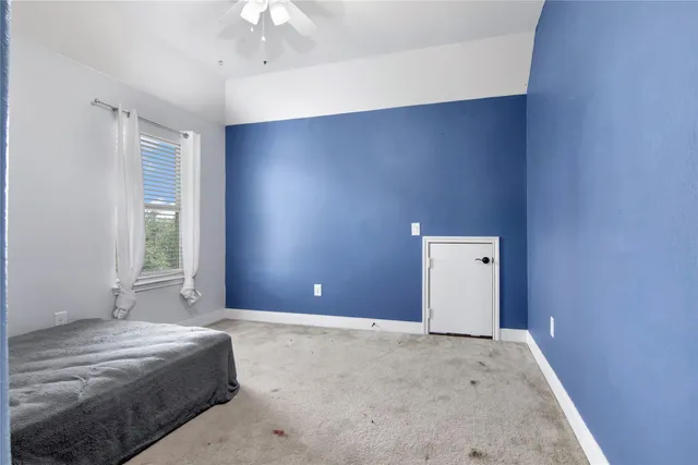 a bathroom with a granite countertop sink toilet and mirror