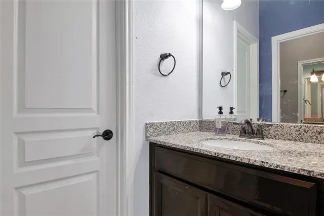 a kitchen with stainless steel appliances granite countertop white cabinets and a granite counter tops