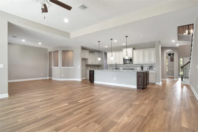 a view of an empty room with glass door and a window