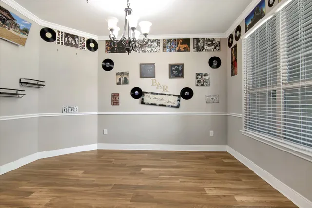 a kitchen with stainless steel appliances granite countertop a sink stove and white cabinets with wooden floor