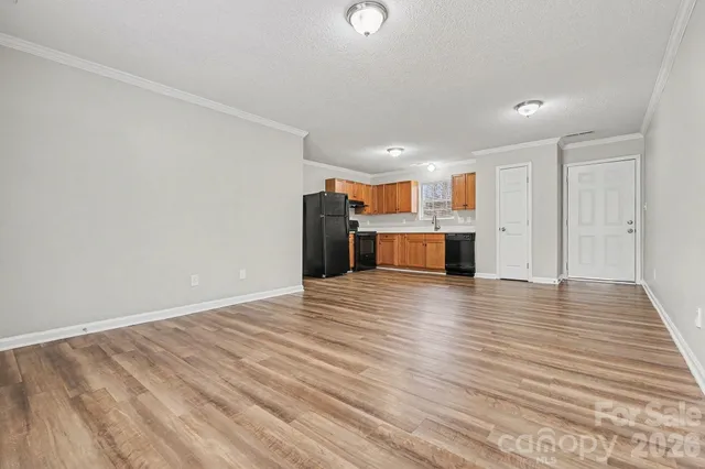 a view of kitchen and hallway with wooden floor