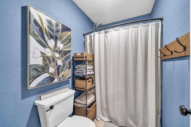 a bathroom with a granite countertop double vanity and a mirror