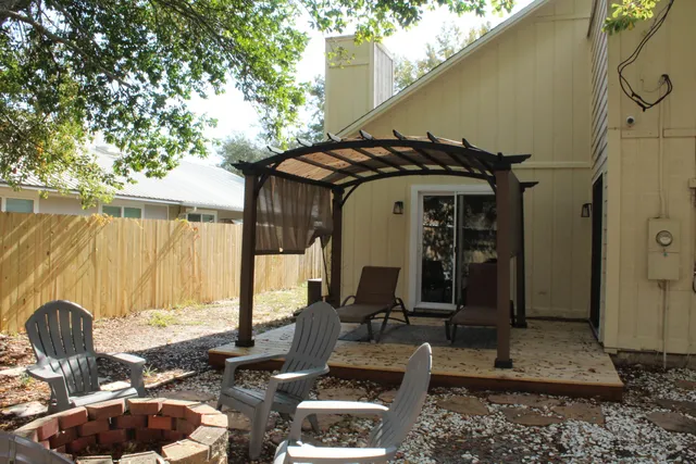 a backyard of a house with table and chairs