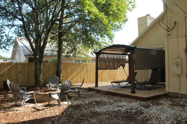 a view of a house with yard and seating area