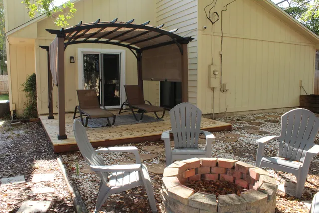 a view of a patio with table and chairs
