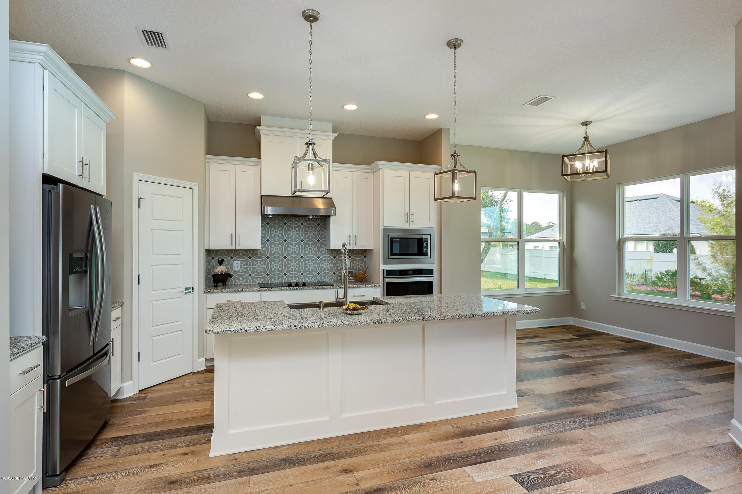 596 West Bianca Circle St. Augustine, FL 32086 - Photo 12 of 37 a large kitchen with stainless steel appliances a large counter top a stove a refrigerator and a sink