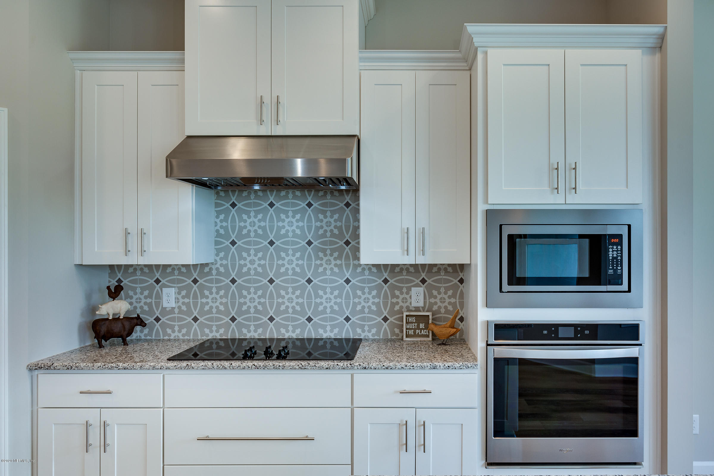 596 West Bianca Circle St. Augustine, FL 32086 - Photo 13 of 37 a kitchen with granite countertop white cabinets and a stove