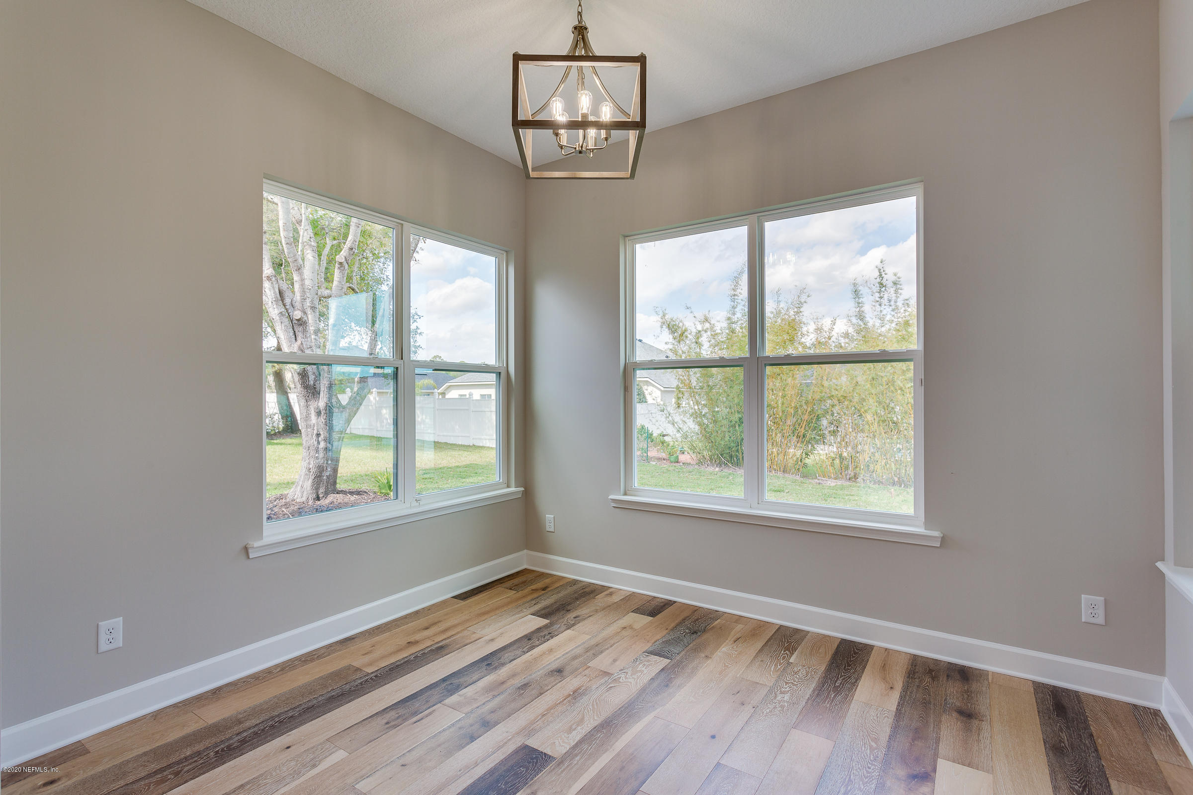 596 West Bianca Circle St. Augustine, FL 32086 - Photo 18 of 37 a view of an empty room with wooden floor and a window