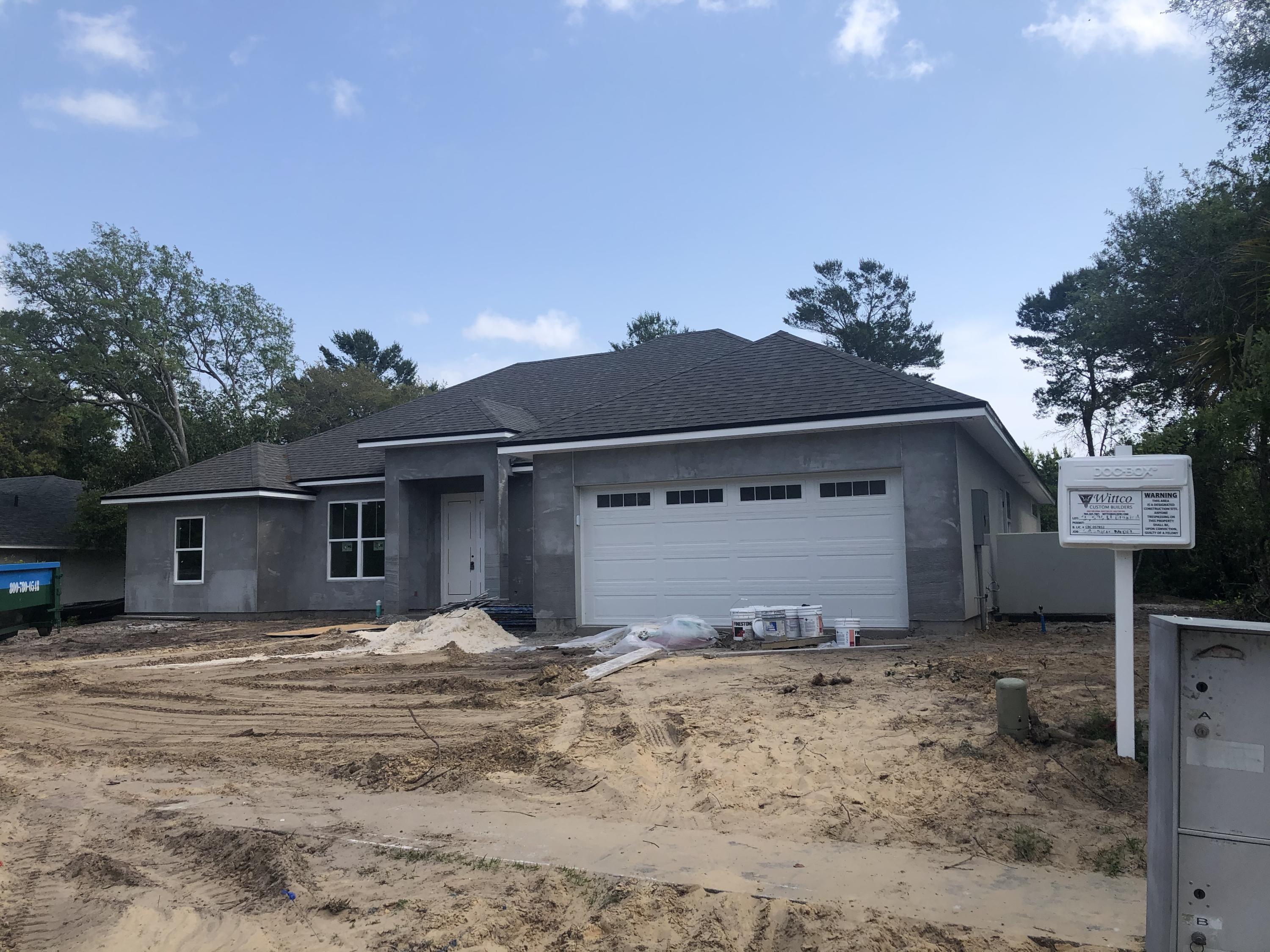 596 West Bianca Circle St. Augustine, FL 32086 - Photo 2 of 37 a front view of a house with a yard and garage