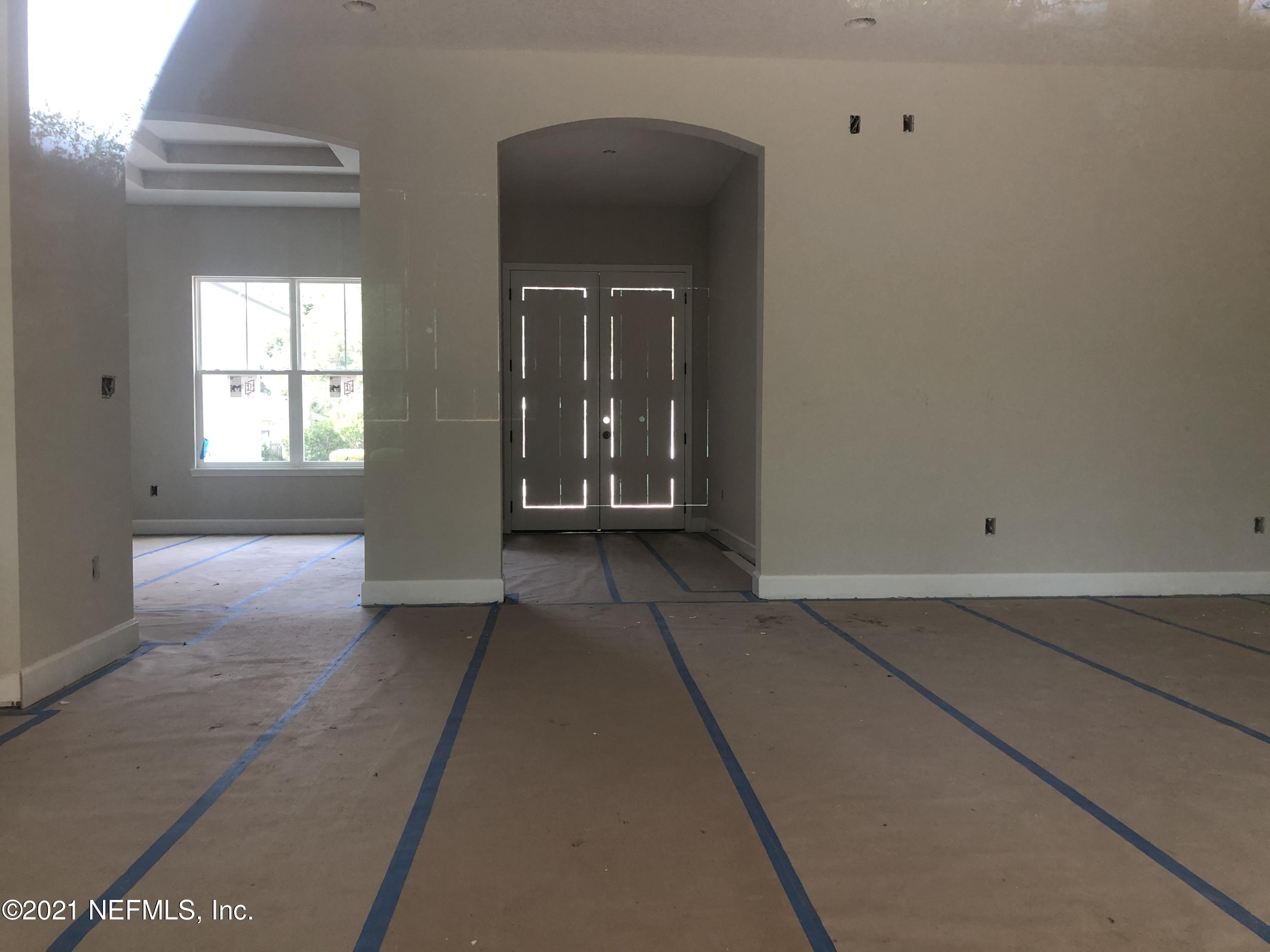 596 West Bianca Circle St. Augustine, FL 32086 - Photo 3 of 37 a view of a hallway with wooden floor and a living room