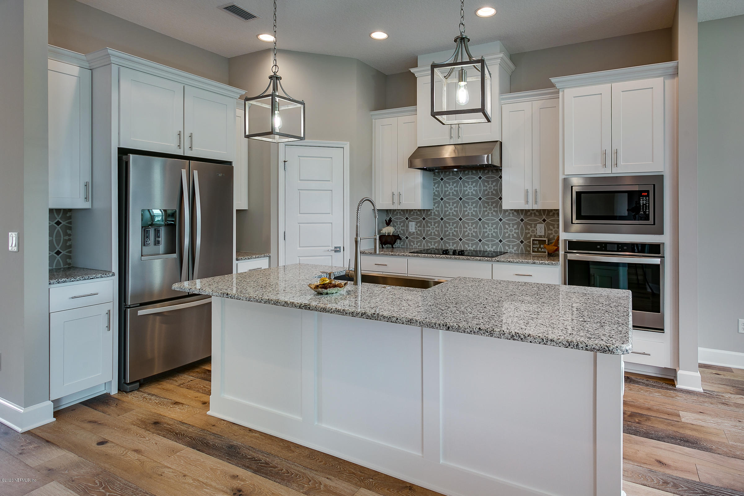 596 West Bianca Circle St. Augustine, FL 32086 - Photo 5 of 37 a kitchen with stainless steel appliances granite countertop a refrigerator and a sink