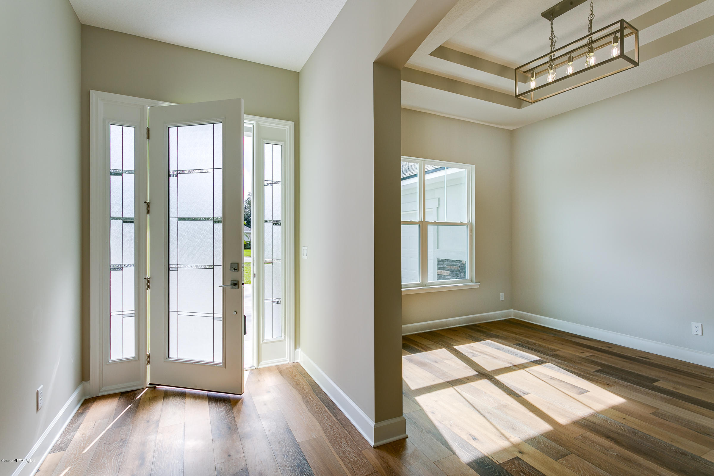 596 West Bianca Circle St. Augustine, FL 32086 - Photo 6 of 37 a view of hallway with window and wooden floor
