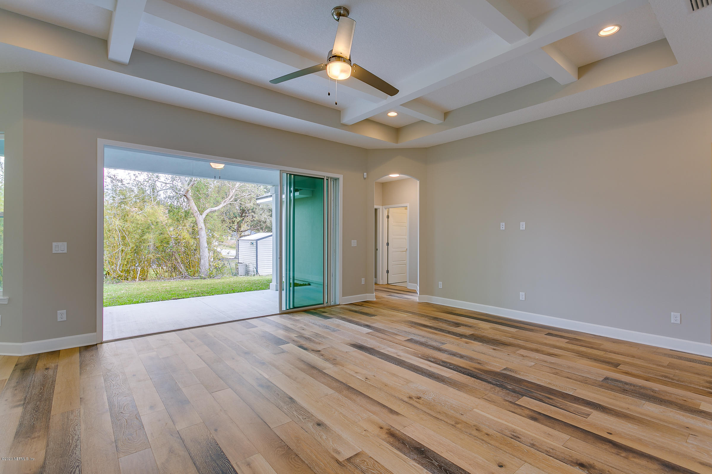 596 West Bianca Circle St. Augustine, FL 32086 - Photo 9 of 37 an empty room with wooden floor and windows