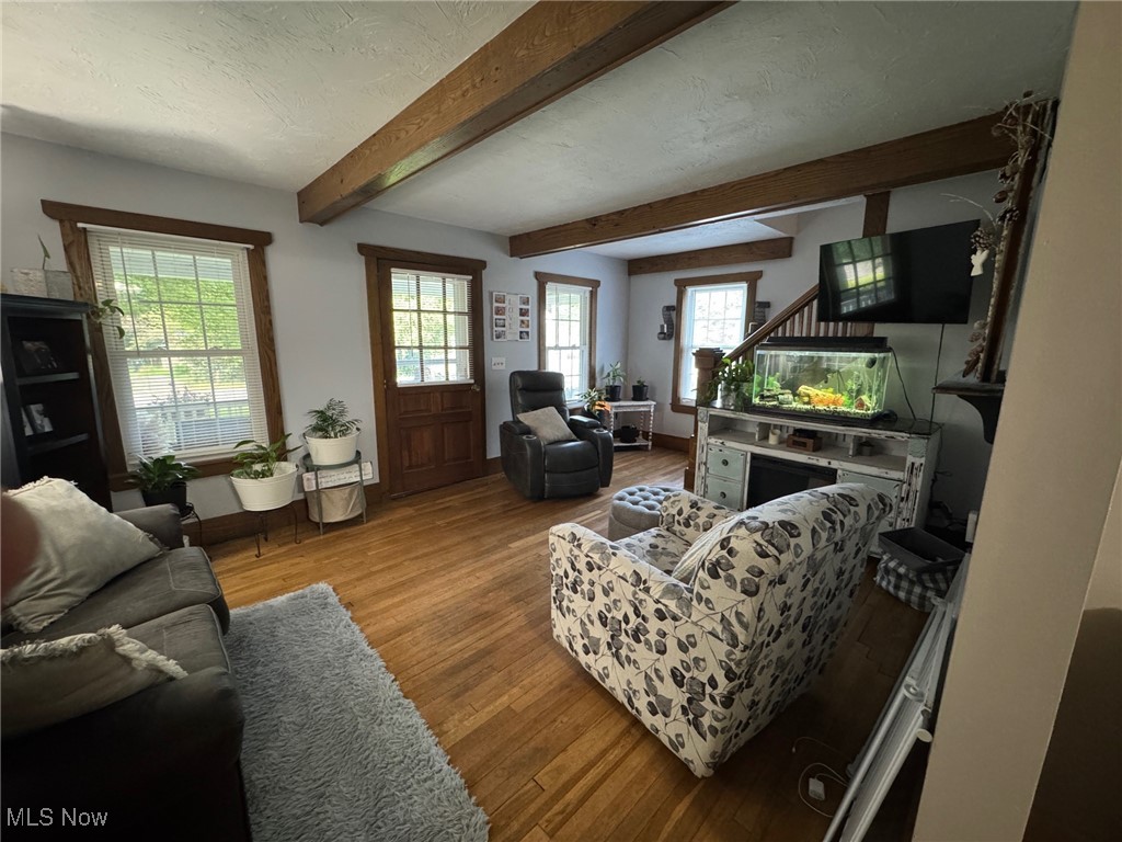 5322 Lockwood Road Madison, OH 44057 - Photo 9 of 30 Living room featuring wood finished floors, and beamed ceiling