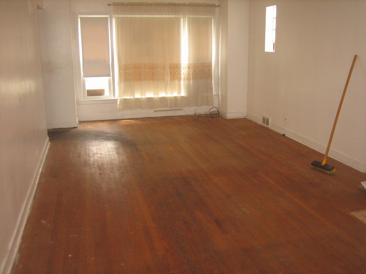 6141 North Harding Avenue Chicago, IL 60659 - Photo 7 of 11 an empty room with wooden floor and windows