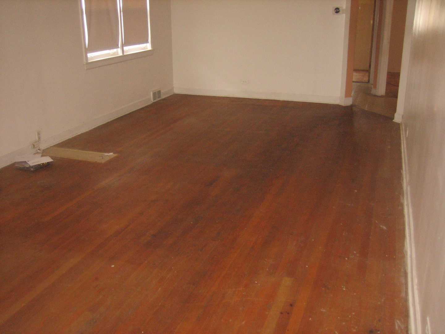 6141 North Harding Avenue Chicago, IL 60659 - Photo 8 of 11 an empty room with wooden floor and windows
