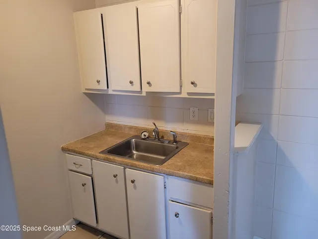 a kitchen with a sink and cabinets