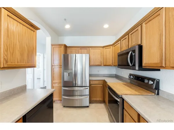a kitchen with refrigerator cabinets and a sink