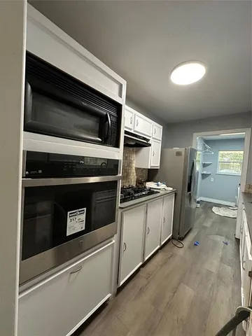 a kitchen with granite countertop cabinets and steel stainless steel appliances