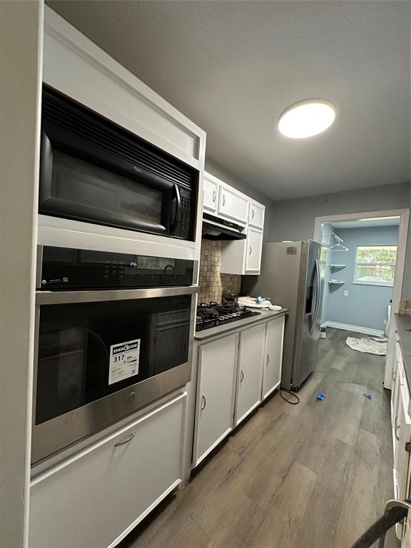 2058 Collins Avenue Abilene, TX 79603 - Photo 2 of 11 a kitchen with granite countertop cabinets and steel stainless steel appliances