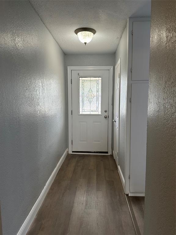2058 Collins Avenue Abilene, TX 79603 - Photo 3 of 11 an empty room with wooden floor and windows