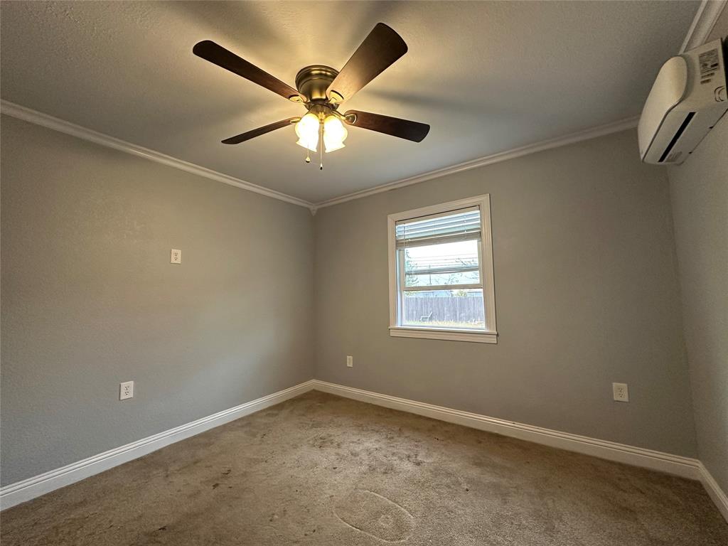 2058 Collins Avenue Abilene, TX 79603 - Photo 5 of 11 an empty room with a window and a fan