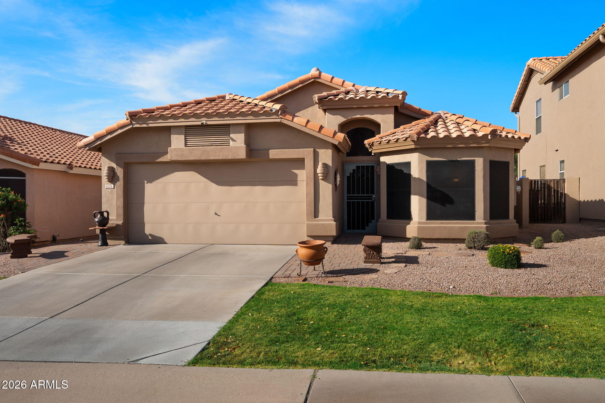 6526 East Raftriver Street Mesa, AZ 85215 - Photo 2 of 17 a view of a house with a yard