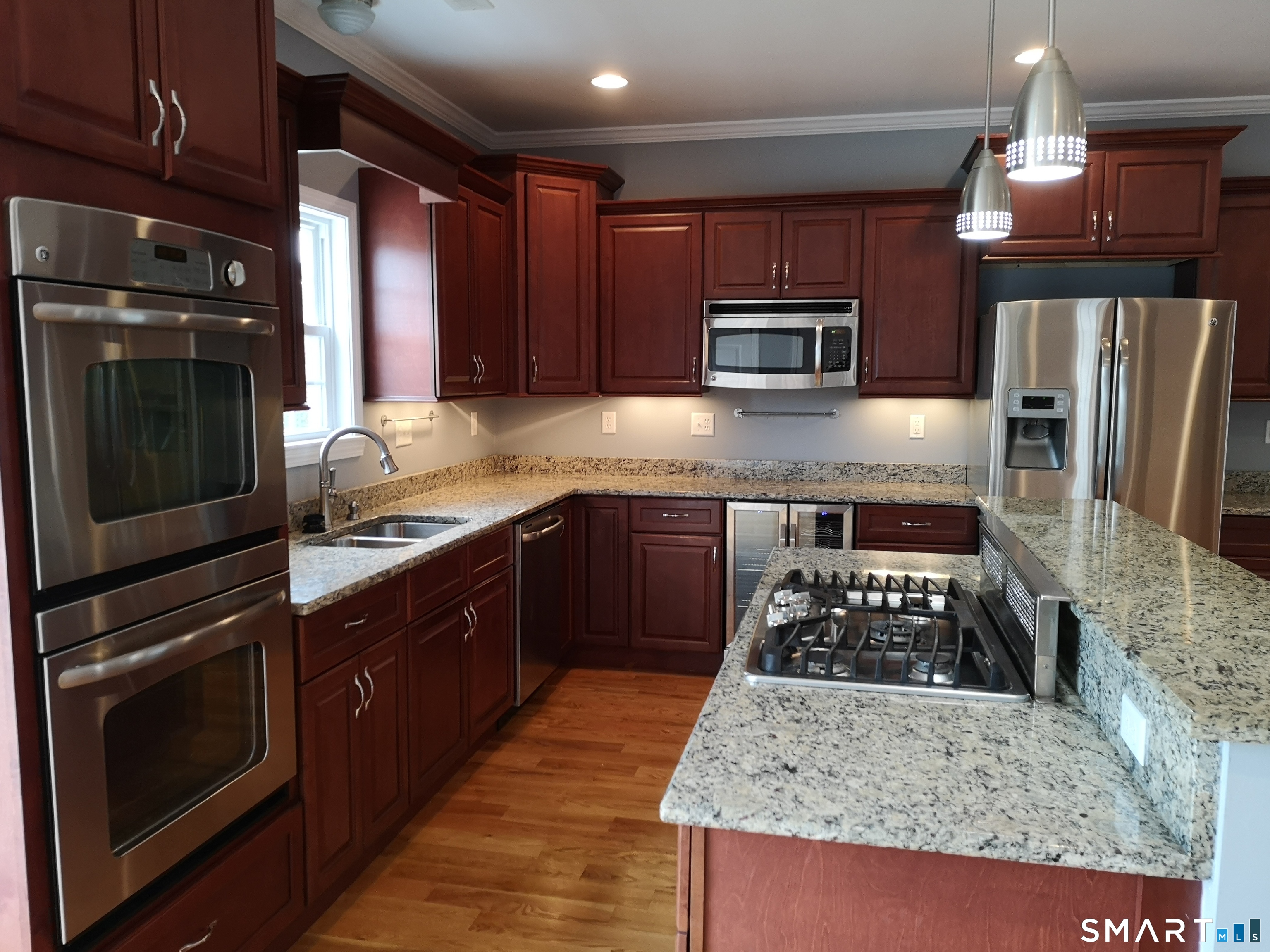 130 Merwin Avenue Milford, CT 06460 - Photo 3 of 22 a kitchen with wooden cabinets and stainless steel appliances