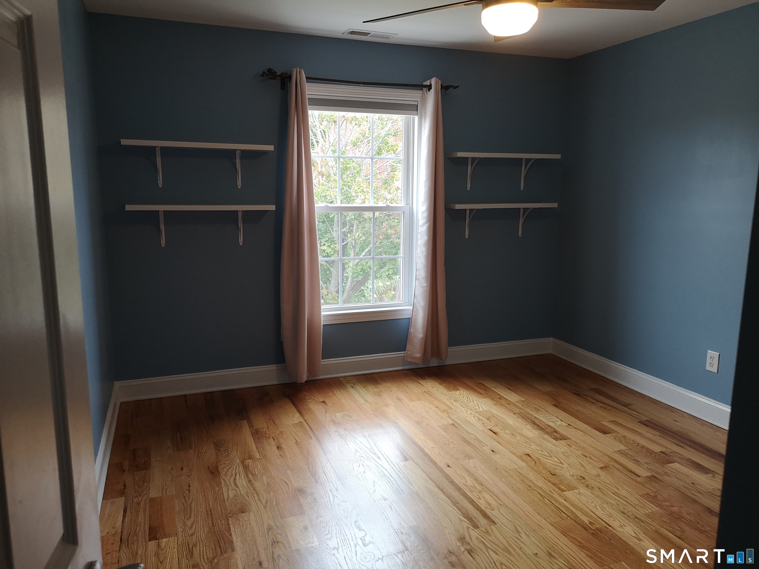 130 Merwin Avenue Milford, CT 06460 - Photo 7 of 22 an empty room with wooden floor and windows