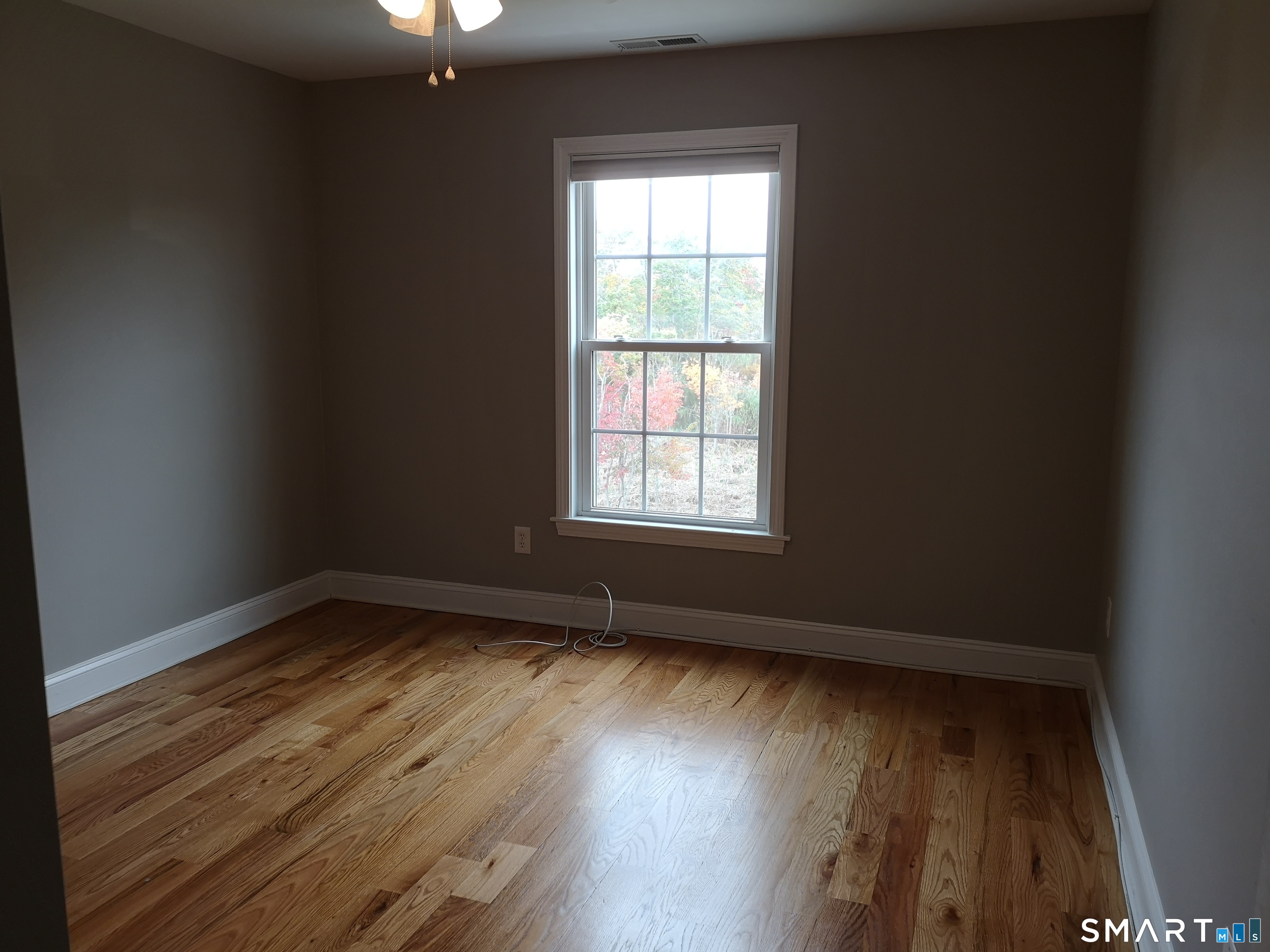 130 Merwin Avenue Milford, CT 06460 - Photo 9 of 22 a view of an empty room with wooden floor and a window