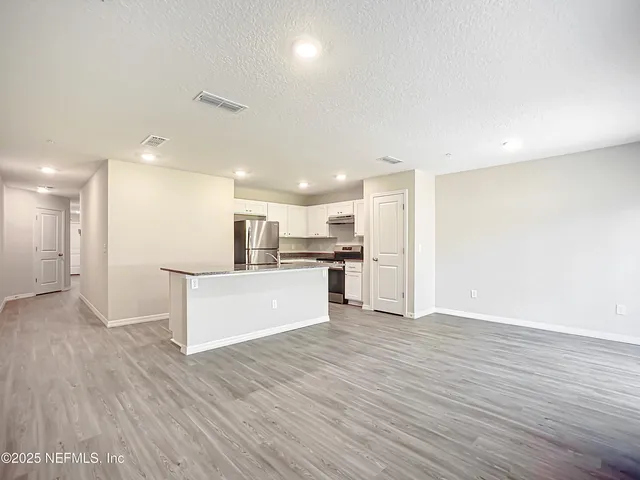 a view of kitchen with wooden floor