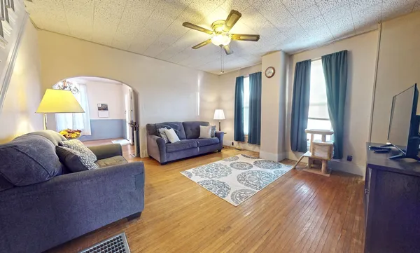 a living room with furniture and a flat screen tv