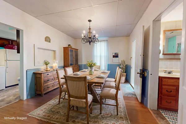 a view of a dining room with furniture and chandelier