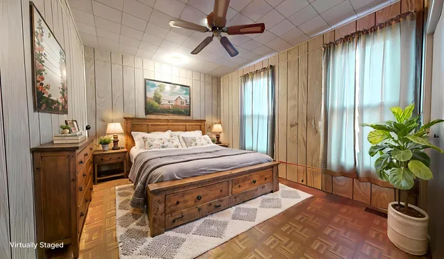 a bedroom with bed and a potted plant