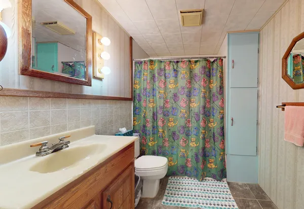 a bathroom with a sink toilet and shower