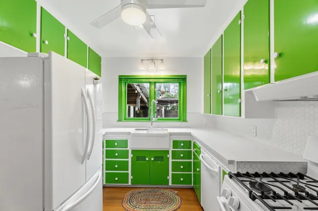 a kitchen with a refrigerator a sink and a large window